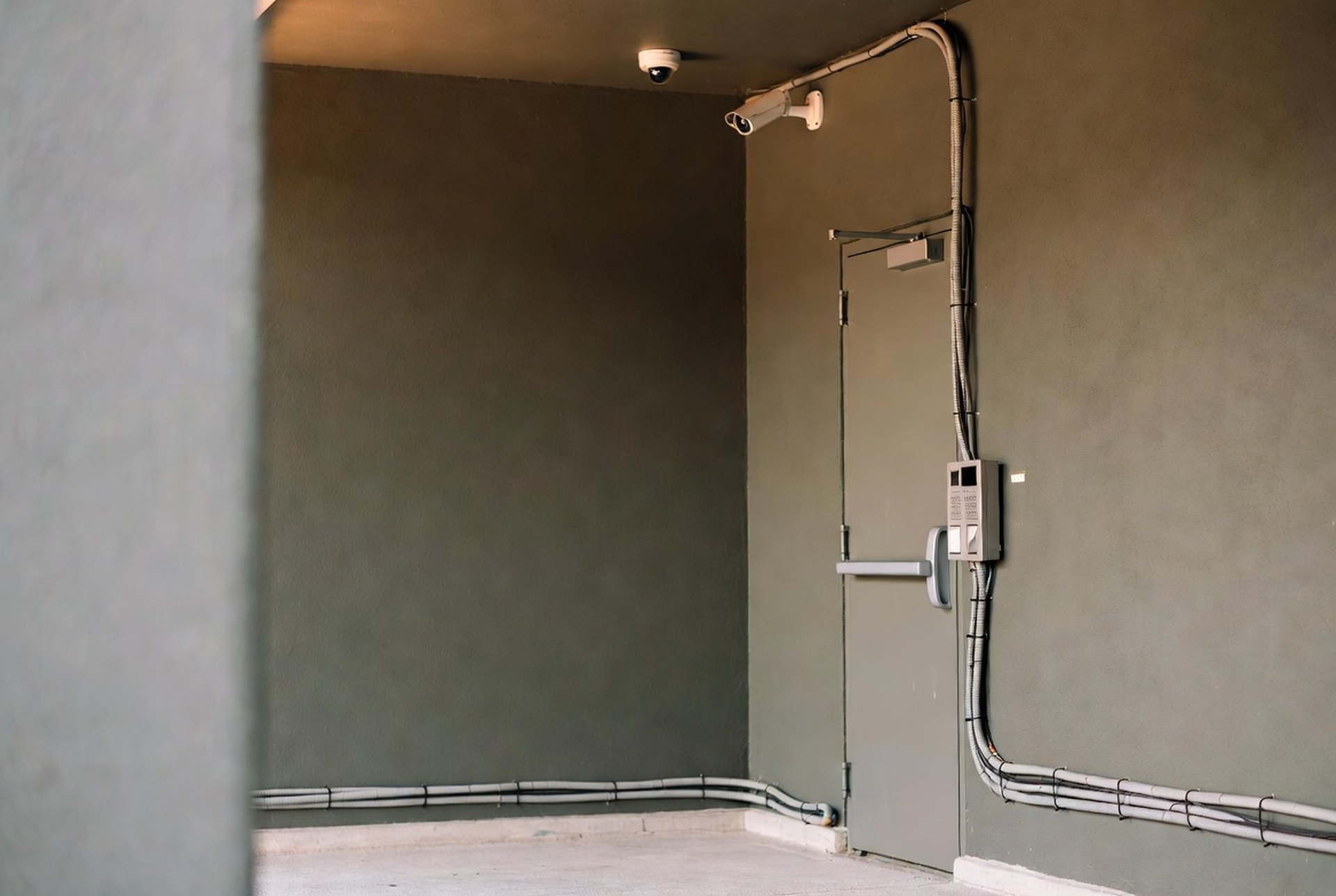 A camera dome and a door reader in a secured entryway