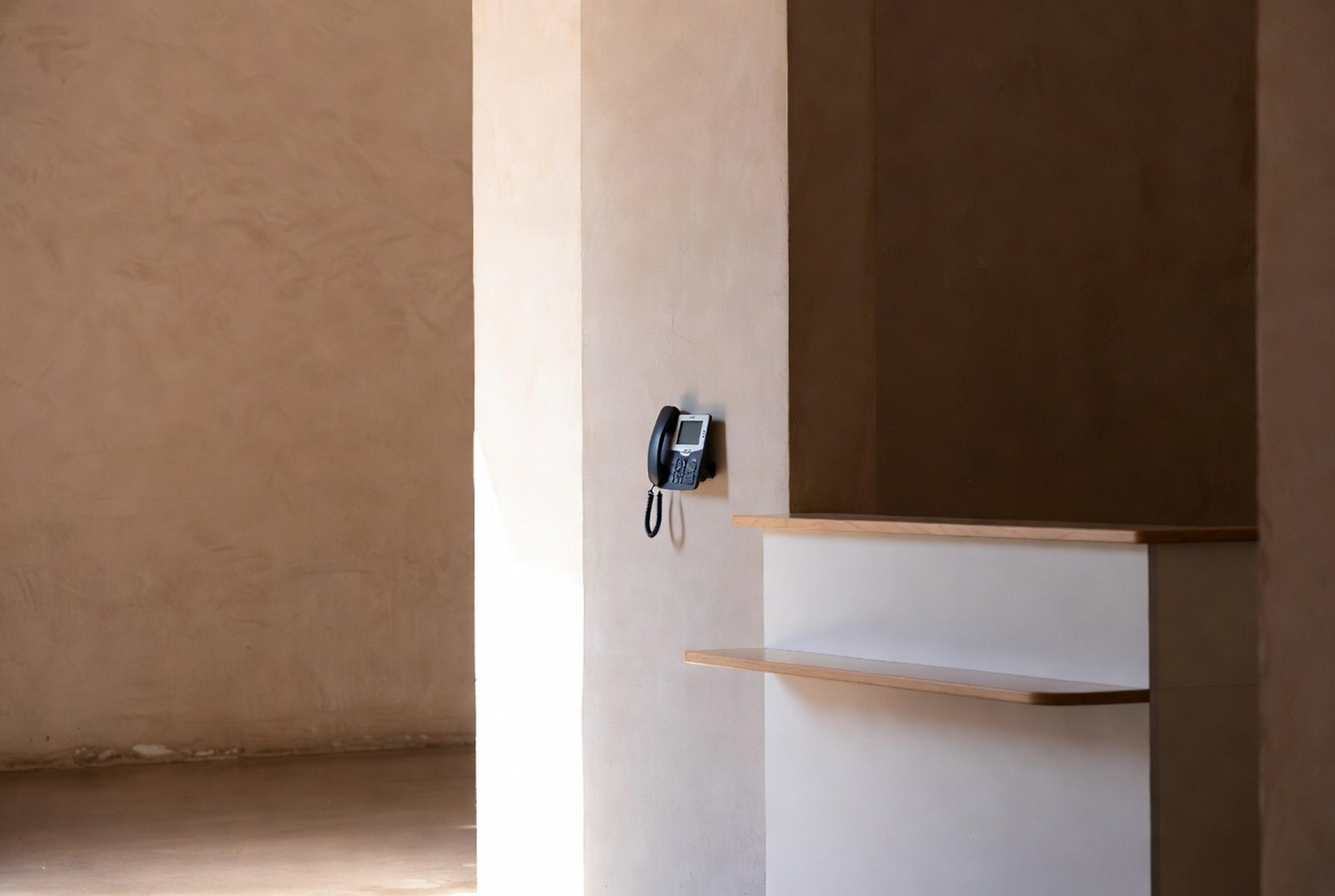 A calm, well-run front office with a wall-mounted IP phone